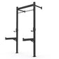 Warrior 4-2 wall-mounted squat rack with black steel frame, dual vertical posts with safety arms and pull-up bar on white bac