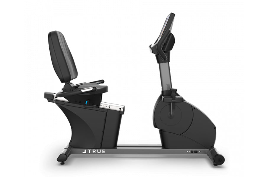 Black commercial recumbent exercise bike with padded seat, digital console, and pedal resistance system on gray base, isolate
