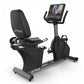 TRUE CS400 commercial recumbent stationary bike with black seat and frame, digital display console, and foot pedals on white 