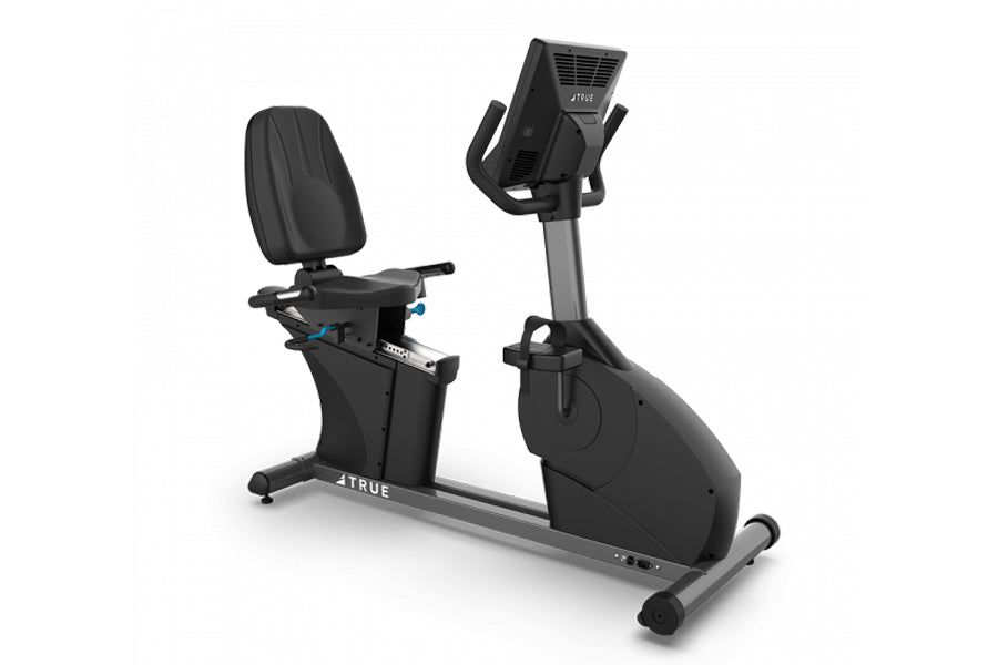 Black and gray TRUE commercial recumbent exercise bike with padded seat, digital console, and adjustable handlebars on white 