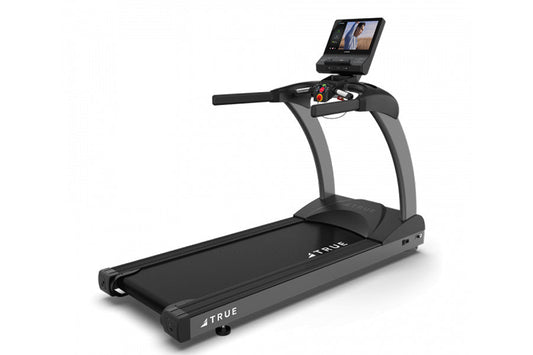 TRUE CS400 commercial treadmill with black running deck, gray frame, and touchscreen display mounted on console, on white bac