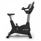 TRUE CS400 commercial upright stationary bike with black frame, gray accents, padded seat and handlebar console on white back