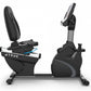 Black recumbent exercise bike with padded seat, gray accents, digital display console, and blue trim detail on white backgrou