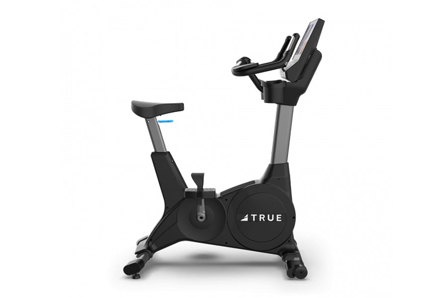 TRUE 900 upright exercise bike with black frame, gray accents, and digital display console on white background
