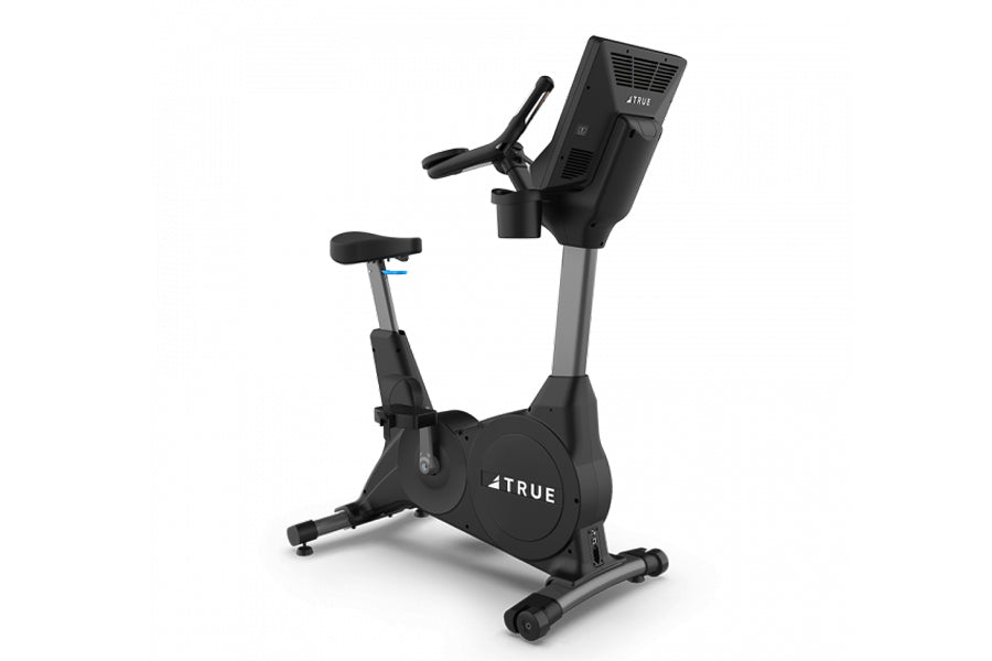 Black and gray TRUE 900 upright exercise bike with digital console display and adjustable seat on white background
