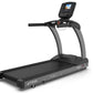 Black commercial treadmill with gray frame, digital display console, and cushioned running belt on white background