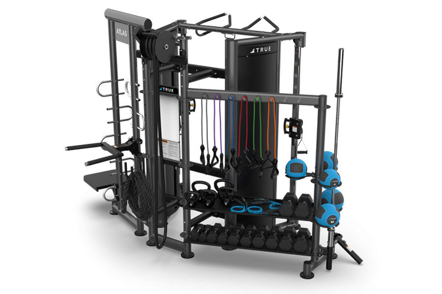 TRUE ATLAS 200 multi-station home gym with black frame, cable machines, resistance bands, blue handles, and dumbbell storage 