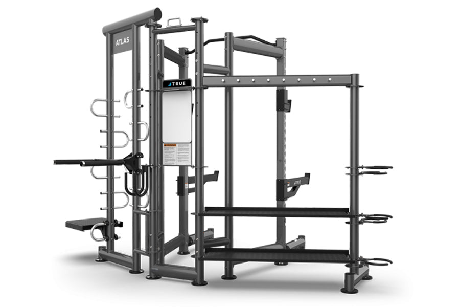 TRUE ATLAS 200 multi-station workout machine with gray steel frame, multiple exercise stations, and black handles on white ba
