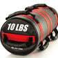 Black and red cylindrical sandbag labeled 10 LBS with carrying handles and reinforced stitching, displayed on white backgroun