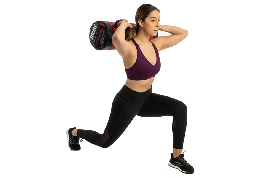 Woman performing weighted lunge exercise while holding burgundy and black Aeromat Extreme Performance Sandbag on shoulder aga