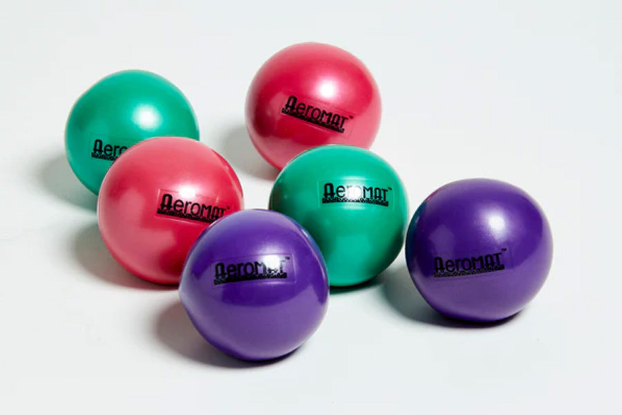 Five glossy Aeromat mini weight balls in teal, pink, red, and purple on white background