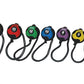 Seven medicine balls with attached rope handles in brown, red, green, blue, purple, yellow, and orange, numbered 18 to 4 poun