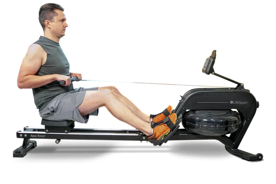 Man using black water rower with orange footrest, seated on rowing machine with display screen against white background