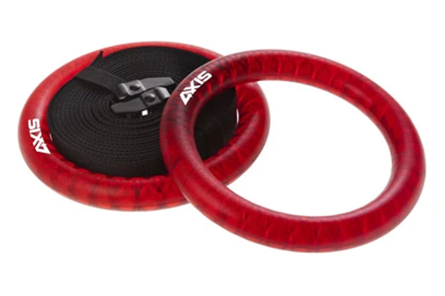 Red velvet gym rings with black webbing straps and metal buckles, displayed on white background