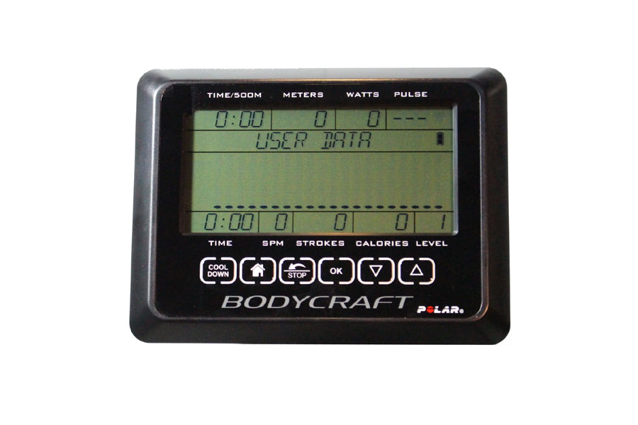 Bodycraft Polar fitness monitor with green LCD display showing time, meters, watts, and pulse data on black background