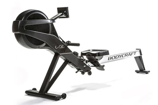 BodyCraft VR400 Pro rowing machine with black frame, fan resistance wheel, and extended seat rail on white background