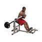 Body-Solid Ab & Back Machine with gray frame, black weight plate, and red seat pad, shown in use by male model on white backg