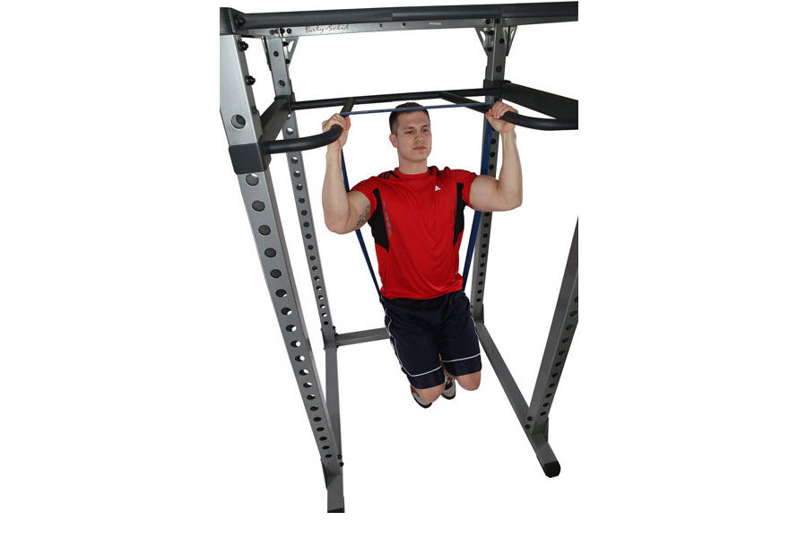 Man performing dip exercise on Body-Solid gray and black metal dip attachment with pull-up bar, worn with red shirt and black