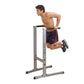 Man using gray and black Body-Solid dip station with horizontal bars, wearing navy shorts and black sneakers