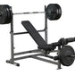 Body-Solid PowerCenter Combo Bench with black weight plates on barbell and leg attachment, gray steel frame on white backgrou