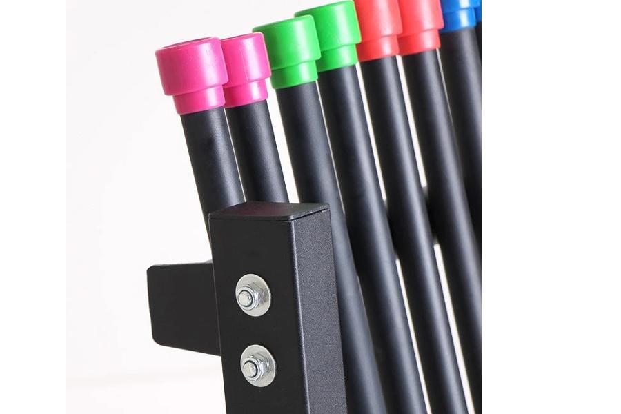 Set of colorful workout bars with pink, green, red, and blue caps in black storage rack holder