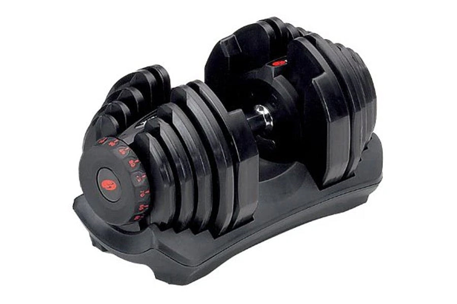 Pair of black adjustable dumbbells with red text markings on weight selector dial, shown in standing position on black base