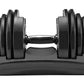 Bowflex SelectTech adjustable dumbbell with black weight plates and red numbered dial, resting on gray base, front view