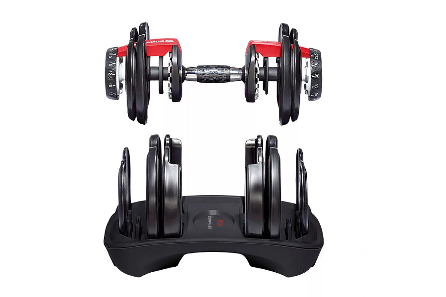 Pair of adjustable red and black dumbbells with weight selector dials on stand, flat lay view