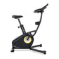 Black upright exercise bike with yellow and gray resistance wheel, black padded seat and handlebars, displayed on white backg