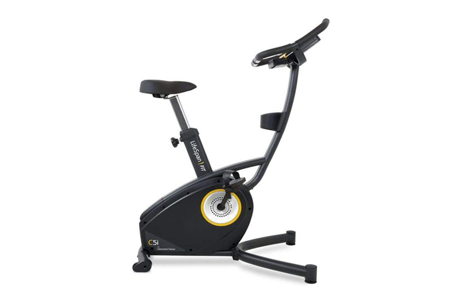 Black upright exercise bike with yellow and gray resistance wheel, black padded seat and handlebars, displayed on white backg