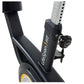 Black upright exercise bike frame with yellow accents and resistance knob, shown at angle on white background
