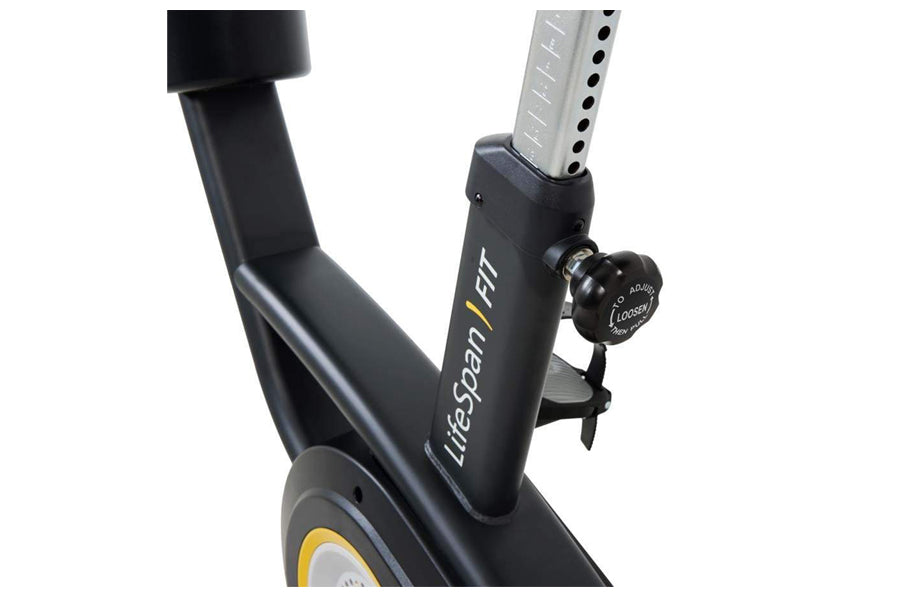 Black upright exercise bike frame with yellow accents and resistance knob, shown at angle on white background