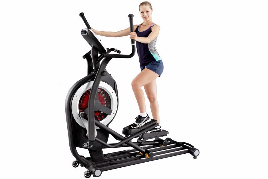Black and white elliptical machine with red wheel display, model shown with woman in dark athletic top and shorts during demo