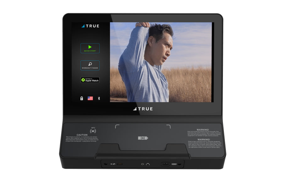 TRUE Envision II black fitness console with 16-inch screen displaying workout video and side menu options on white background
