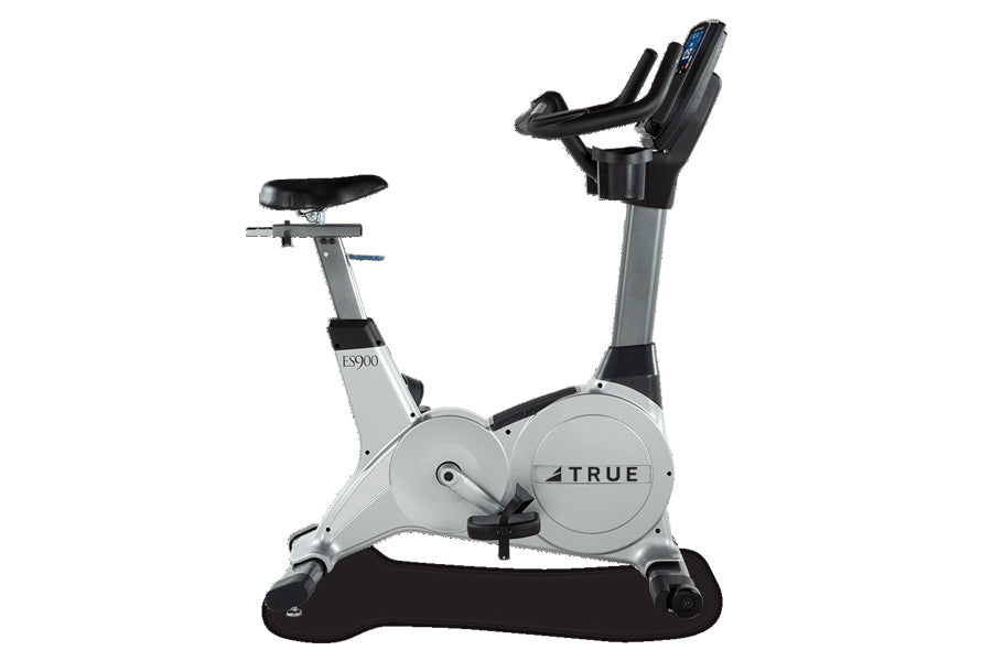 TRUE ES900 upright exercise bike with white and gray frame, black seat and handlebars, digital display, shown on white backgr