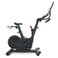 Black upright exercise bike with digital display, adjustable handlebars, padded seat, and weighted flywheel, on white backgro