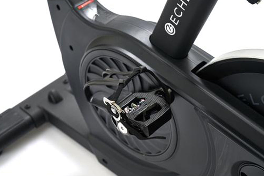 Black stationary exercise bike with pedal platform detail and Echelon branding on seat post, white background