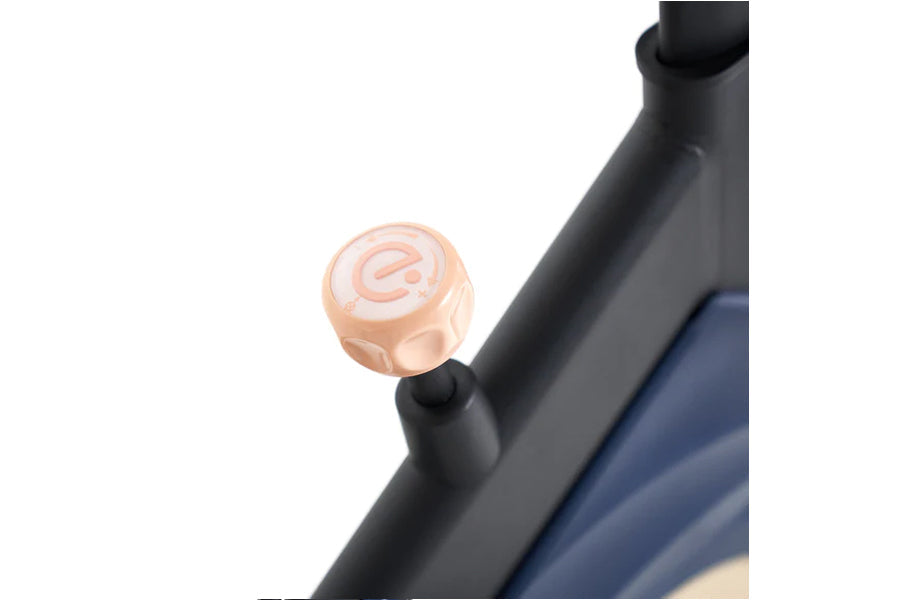 Rose gold bell with "e" logo mounted on black bike frame handlebars