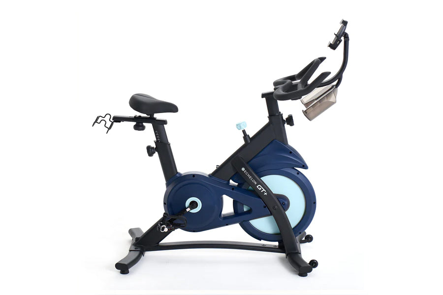 Navy and black stationary exercise bike with light blue flywheel, digital display, and dual handlebars on white background