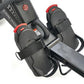 Echelon rowing machine footrests with black perforated material, red straps, and metal frame on white background