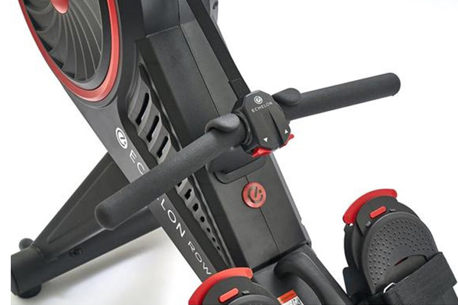 Black and red Echelon connected rowing machine with digital console and flywheel, shown at angle on white background