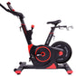 Black and red stationary exercise bike with digital display, adjustable handlebars, and foot pedals on white background
