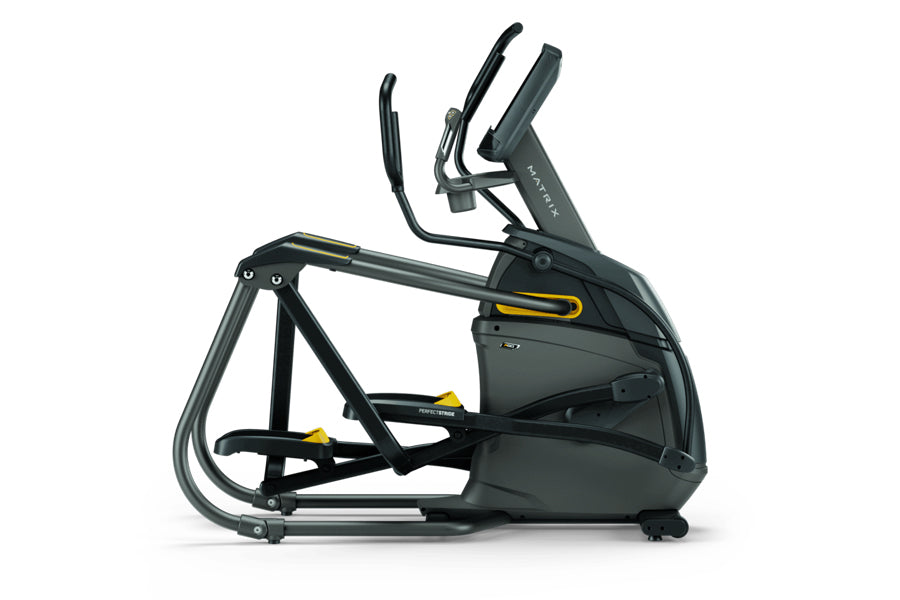 Black elliptical trainer with yellow accents, dual handles, pedals, and digital display on white background