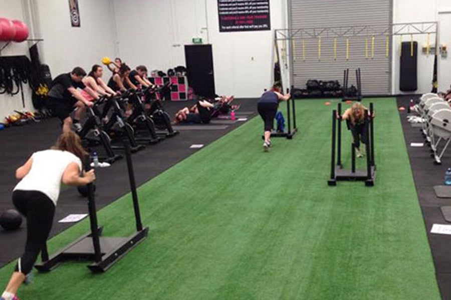 Warrior Firm Turf artificial grass flooring in indoor fitness gym with athletes training