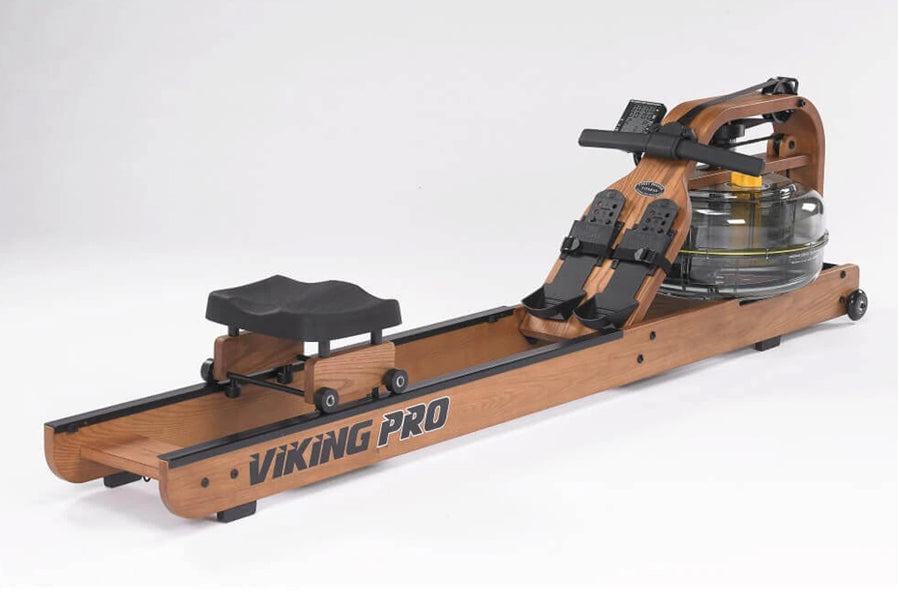 A Viking Pro indoor rowing machine with a wooden frame and black accents, featuring a water tank and black seat.