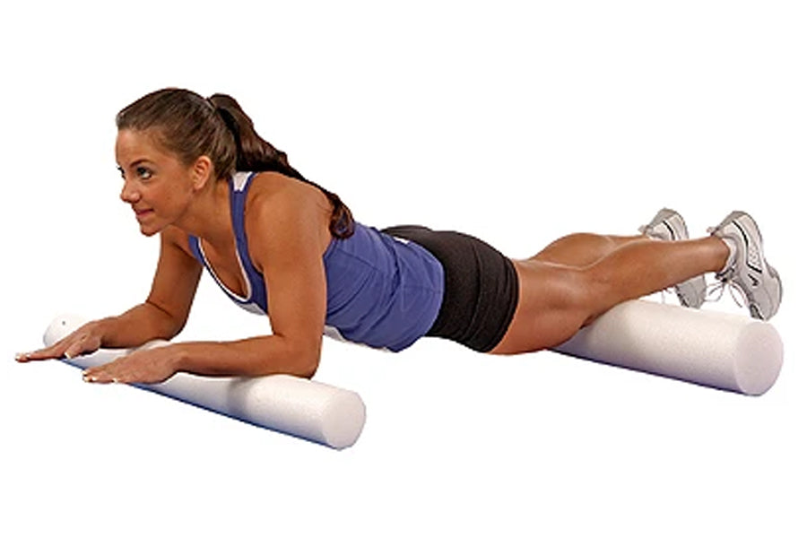 Woman in blue sports bra and black shorts performing plank exercise on white foam roller with reinforced core