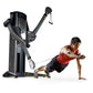 Black and gray dual cable cross exercise machine with model demonstrating suspended plank position using resistance cables