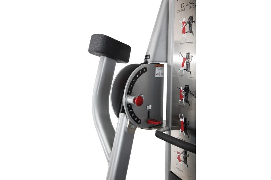 Freemotion Genesis G624 dual cable cross machine with gray frame, black padded handles, red weight selector, and instruction 