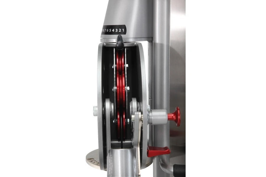 Freemotion Genesis G624 Dual Cable Cross machine detail showing red pulleys and silver metal frame on white background