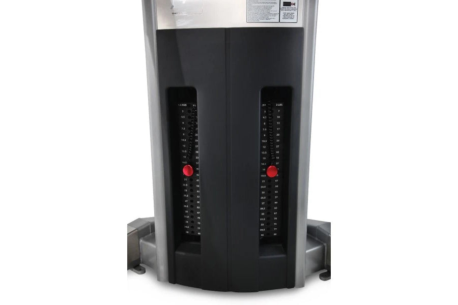 Freemotion Genesis G624 dual cable crossover machine with black panels, dual red adjustment knobs, and numbered weight stacks